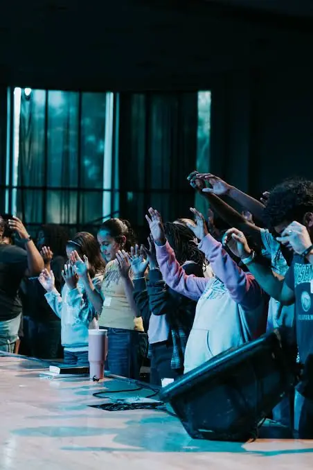 Students worshipping with hands raised