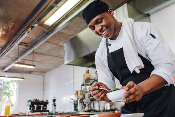 Chef plating a dish in the kitchen